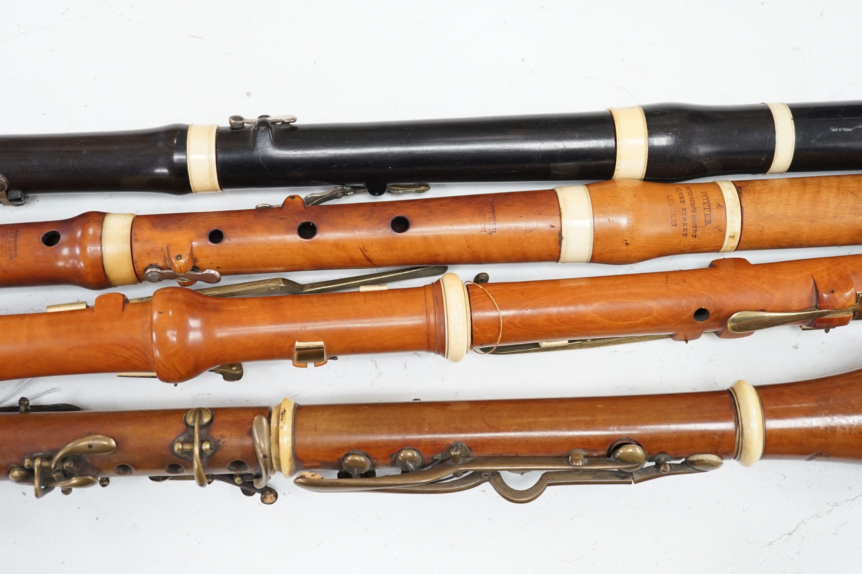 Two 19th century flutes by W. Potter, one in boxwood, the other ebony, and two 19th century boxwood clarinets, one by Dollard, the other by Lazarus